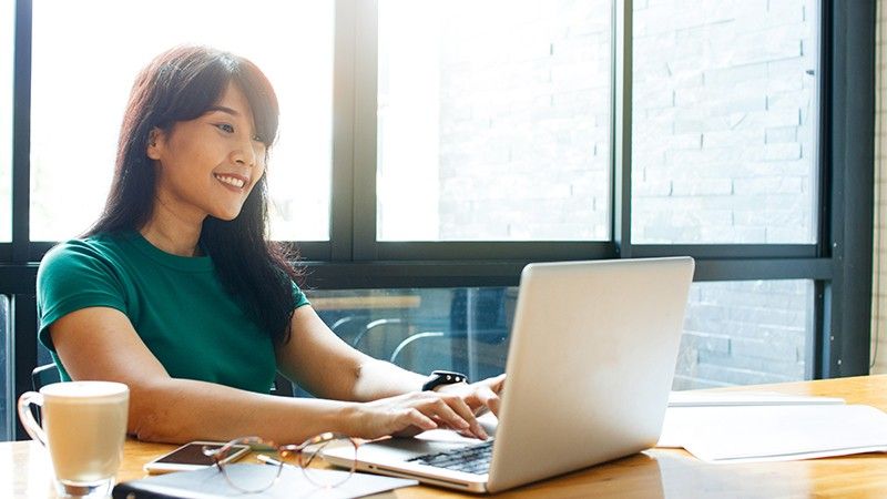 young owner business woman working online, checking mail on laptop organizing working process in office.