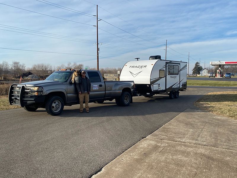 Doug Bicknell transporting RVs with his travel buddy, Tucker 