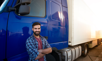 Trucker in front of vehicle fleet factoring