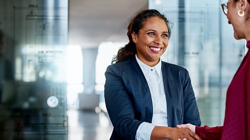 Shot of two businesswomen shaking hands in a modern office