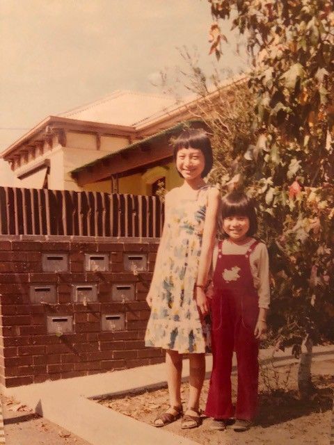 Marie Yip, on her first day of school in Australia, posing with her cousin