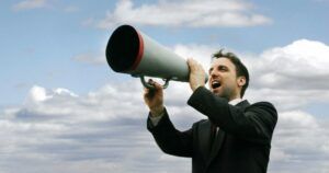 man yelling into a megaphone