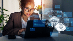 Woman using laptop with brain graphic overlay