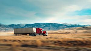 long haul truck crossing an empty field