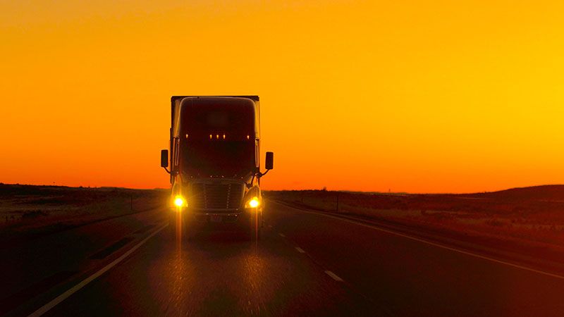 long-haul truck in sunset